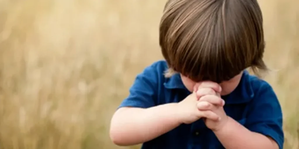 Child Praying in Field